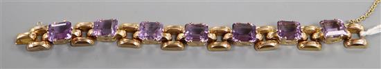 A yellow metal (tests as 18ct according to 1990 insurance valuation) and seven stone amethyst set bracelet, approx. 16.5cm.